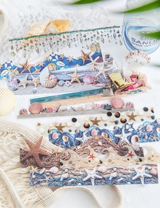Macro detail of ocean-themed stickers featuring seashells and starfish on white stone