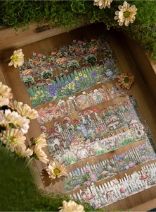 Detail of vintage mushroom and forest stickers in a rustic wooden tray with green moss