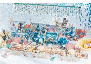 Macro shot of marine life stickers including shells and corals on a rippled background