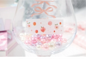 Close-up of decorative peach illustration stickers on a glass with sparkling finish