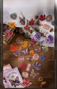 Detail of vintage embroidery-style stickers featuring butterflies and plants on lace