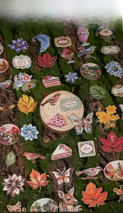 Detail of forest style embroidery stickers featuring flowers and animals on rustic wood