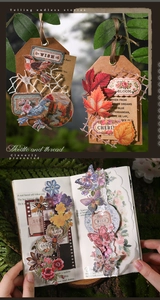 Detail of vintage hand embroidery style stickers with nature motifs on journal pages