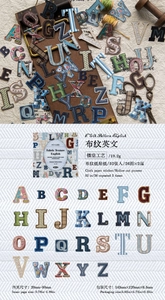 Macro detail of vintage alphabet stickers with fabric texture for DIY scrapbooking decor