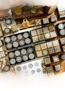 Detailed view of vintage floral wooden stamps set with elegant lace patterns and paper box