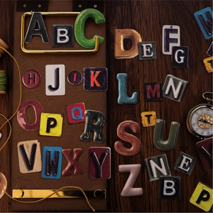 Retro 3D alphabet sticker set for journaling on dark wood and vintage display