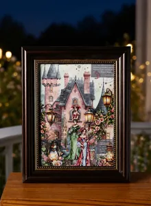 Detail of vintage European castle illustration and decorative lamp stickers in a wooden frame