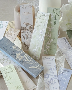 Detailed close-up of vintage embossed floral bookmarks with elegant poetry script
