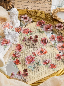 Detail view of vintage watercolor floral PET stickers on antique manuscript and gold tray