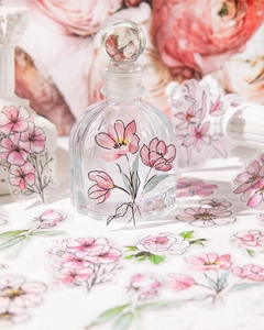 Detailed close-up of watercolor floral PET stickers applied to a clear glass vase