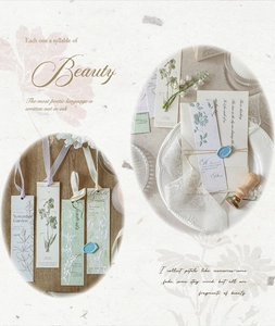Close-up of vintage floral bookmarks with silk ribbons and wax seal stamps on textured paper