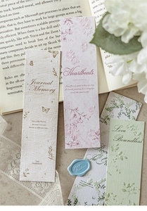 Macro detail of vintage floral bookmarks with embossed gold foil and butterfly patterns