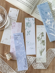 Detail of embossed floral paper bookmarks with vintage textures in a blue gift box