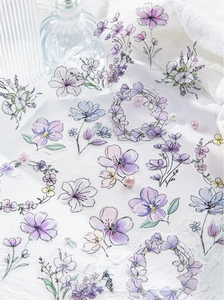 Detailed macro of translucent PET floral stickers with elegant gold foil stamping and watercolor patterns
