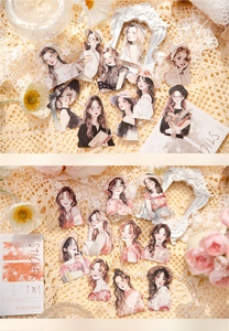 Close-up of hand-drawn vintage girl stickers with intricate die-cut details for DIY journals