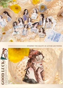 Detail of artistic girl stickers for DIY journals on lace fabric and glassware