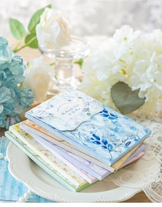 Close-up of vintage floral scrapbooking paper pack with delicate botanical patterns