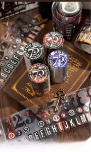 Close-up of vintage YANJI DESIGN decorative tapes with newspaper and font patterns