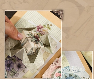 Detail of vintage scrapbooking paper with floral patterns and Roman numeral clock designs