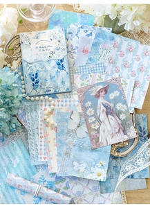 Detail of 50 sheets blue vintage scrapbooking paper with floral and butterfly patterns