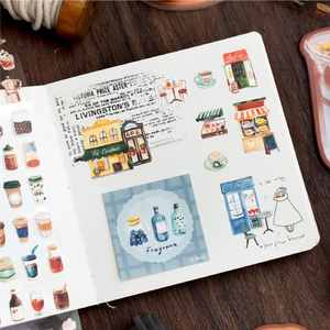 Daily life theme decorative washi tape set on journal book over a wooden table