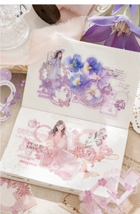 Close-up of romantic purple and pink PET stickers applied on a grid paper journal