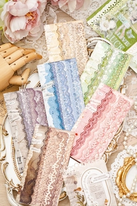 Detailed view of vintage hollow lace paper strips for DIY scrapbooking decoration