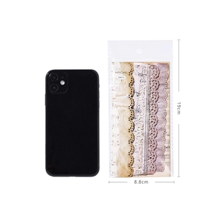 Lace hollow sticker pack for scrapbooking next to a smartphone for size reference
