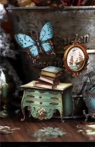 Detail of vintage scrapbooking cards featuring blue butterflies and classic antique motifs