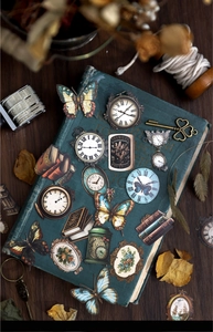Macro detail of vintage stationery stickers with clocks and butterflies on antique book cover