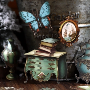 Vintage butterfly and Victorian style scrapbook stickers on dark wood grain surface