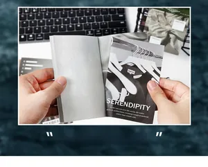 Detail of DIY scrapbook paper featuring artistic text and black-and-white scenery scenes