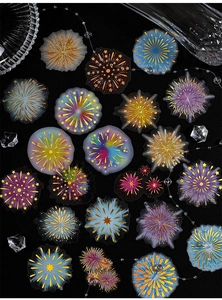 Flat lay of colorful firework-themed DIY stickers with sparkling crystal decorations