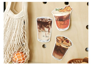 Detail view of coffee-themed decorative stationery stickers on a wooden pegboard display