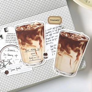 Artistic coffee themed scrapbook stickers featuring latte illustrations on a grid notebook