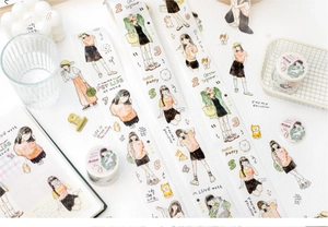 Detail of decorative washi tape with hand-drawn girls and pets for DIY journaling
