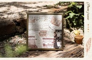 Detailed view of vintage scrapbook paper featuring French manuscript in a gold metal frame