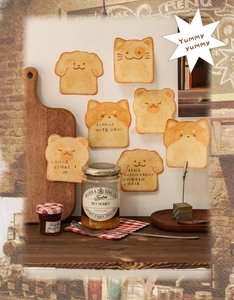 Macro detail of cute animal toast sticky notes featuring dogs and bears on a wooden board