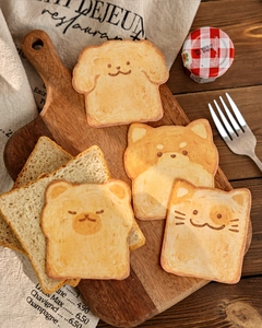 Macro shot of cute toast-shaped animal stickers on a rustic wooden board with kitchen props