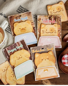 Detailed view of 30pcs cute cartoon toast animal sticky notes on a warm desktop