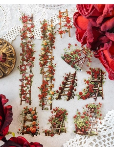 Close-up of vintage flower ladder stickers with red roses for DIY scrapbooking