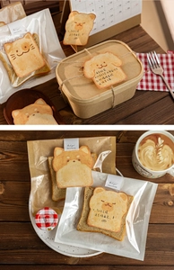 Close-up of cute toast-shaped animal memo stickers and decorative gift labels on wood