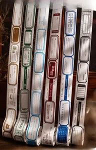 Macro view of vintage ticket style die-cut washi tape rolls with retro stamp details