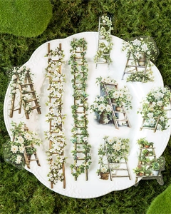 Floral ladder stickers for scrapbooking displayed in a white plate with green moss