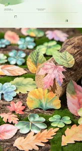 Macro shot of laser-cut lifelike leaf stickers featuring autumn maple and ginkgo shapes