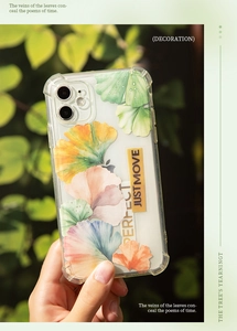 Clear iPhone case with green leaf patterns and protective reinforced corners in sunlight