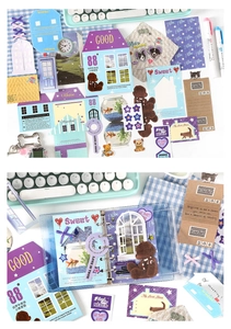 Detailed spread of vintage scrapbooking stickers, cards, and a transparent binder set