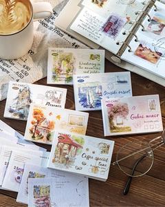 Macro view of vintage travel stamp stickers featuring watercolor scenes on dark wood