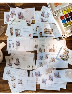 Macro shot of 50 vintage post-themed stationery cards with retro stamps and sketches