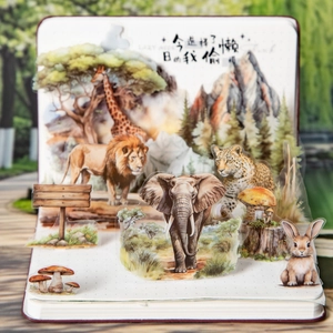 Artistic PET animal stickers featuring forest scenes and wildlife on a journal page